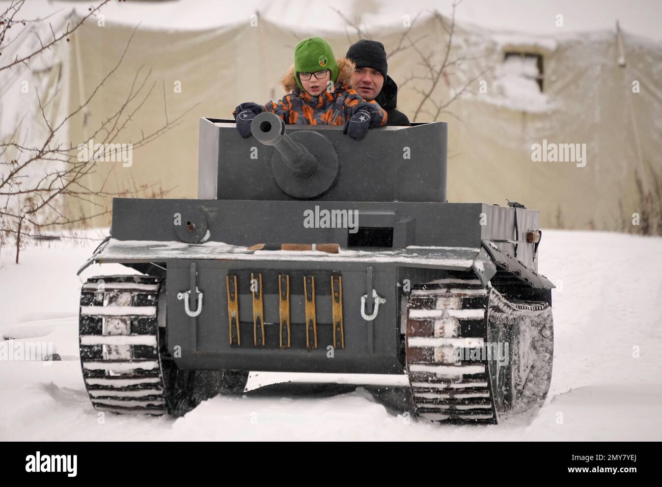 A man and his child ride a model of World War II times German Tiger I ...