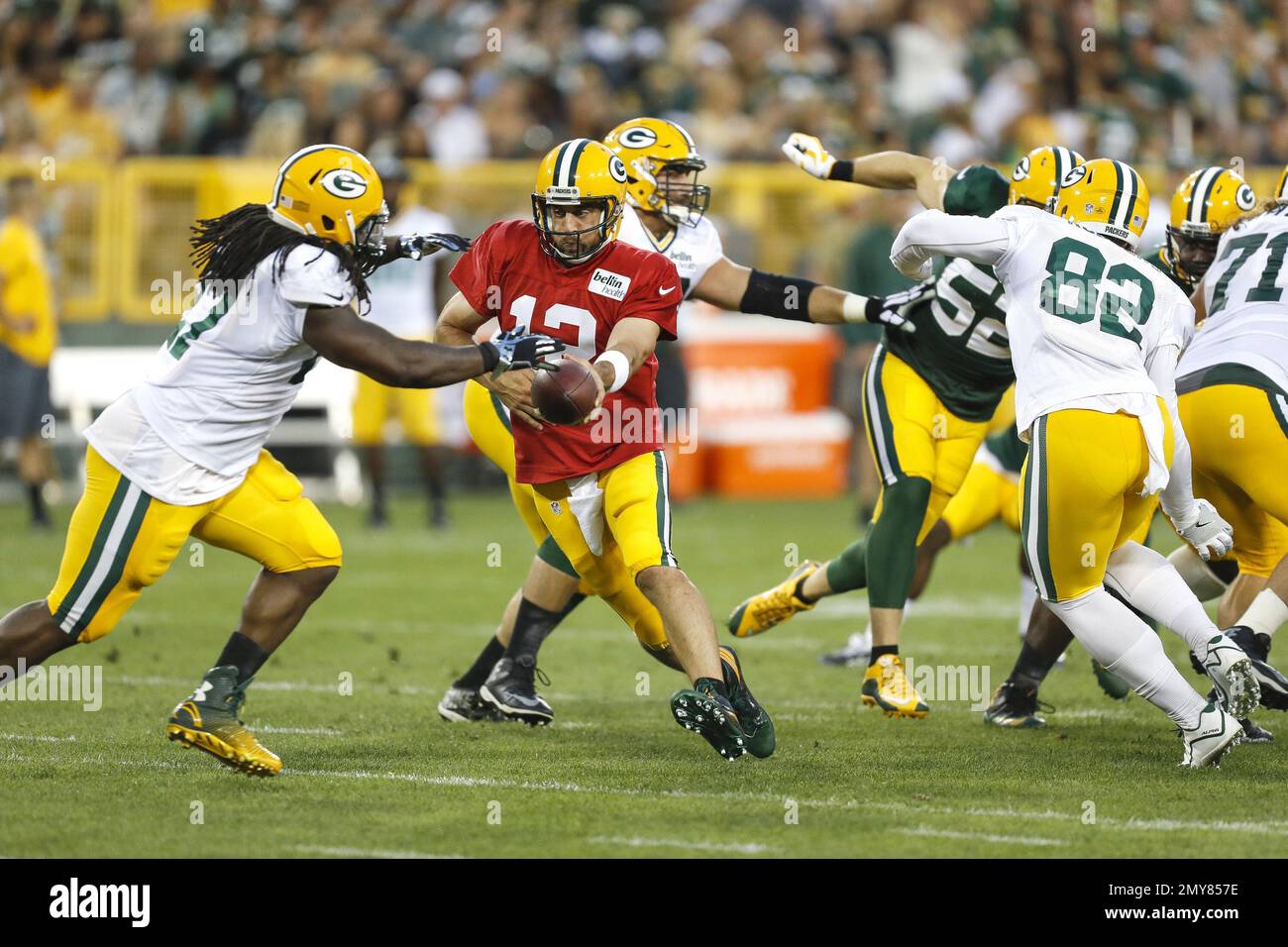 Green Bay Packers quarterback Aaron Rodgers hands the ball off to ...