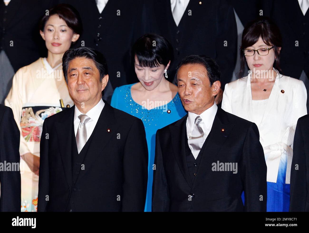 Shinzo Abe, left, member of Japan's House of Representatives and acting  secretary general, talks with Yasuhisa Shiozaki, also a house member and  chairman of the Committee of Judicial Affairs, as they visit