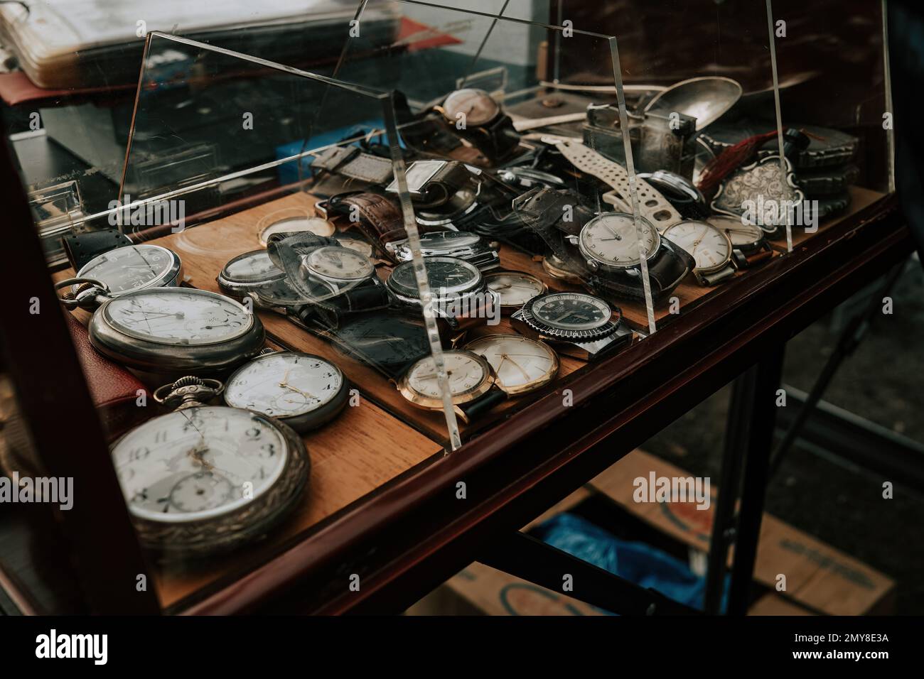 Showcase with old watches on flea market. previously used clock, retro design. High quality photo Stock Photo