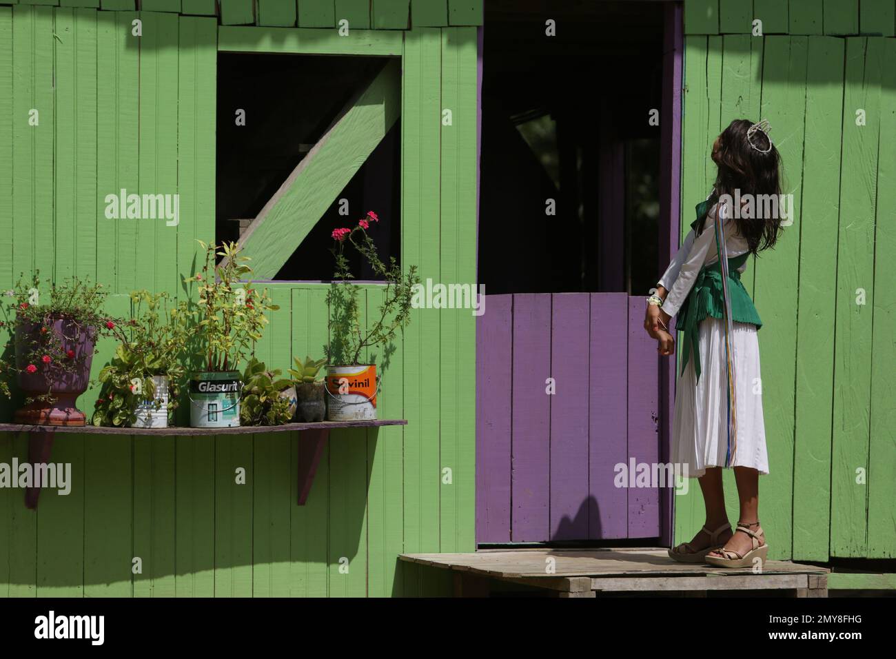 In this June 22, 2016. photo, 12yearold Maria Clara, preens in front