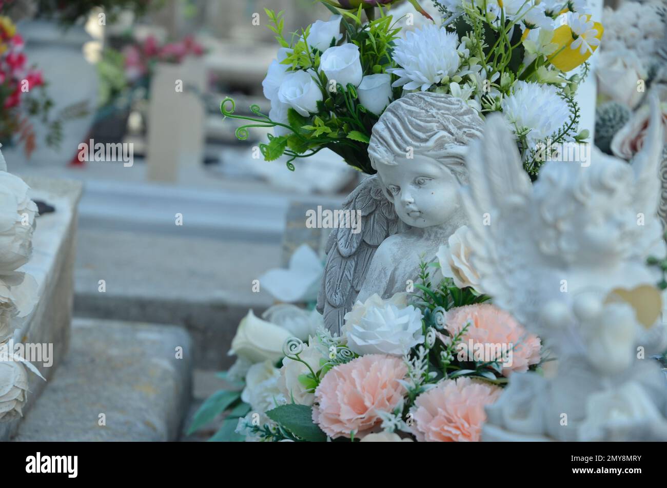 sculpture and a flowers on a tomb Stock Photo Alamy