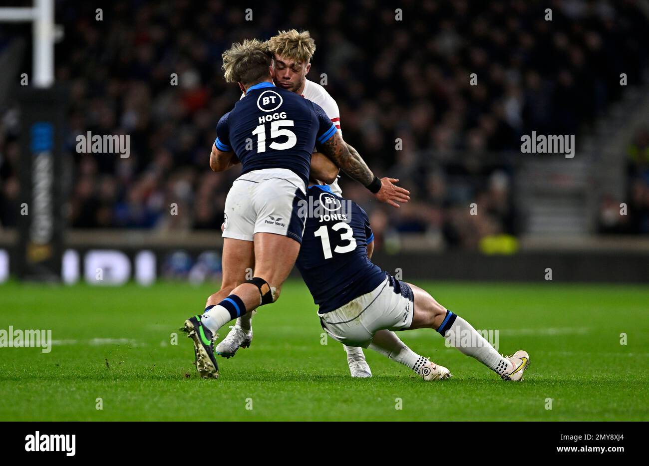 Twickenham, United Kingdom. 04th Feb, 2023. England V Scotland, Culcutta Cup, Guinness 6 Nations. Twickenham Stadium. Twickenham. Ollie Hassell-Collins (England) is tackled by Stuart Hogg (Scotland, 15) and Huw Jones (Scotland) during the England V Scotland, Culcutta Cup rugby match in the Guinness 6 Nations. Credit: Sport In Pictures/Alamy Live News Stock Photo