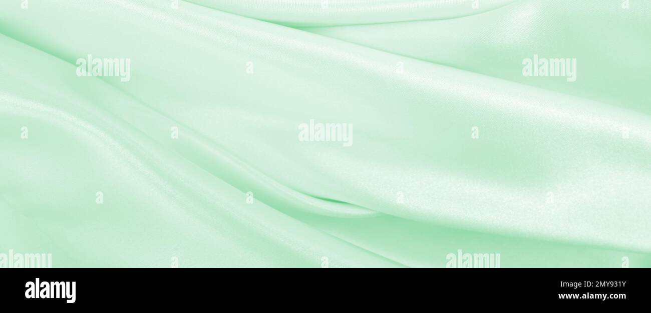 Smooth elegant green silk or satin luxury cloth texture can use as ...