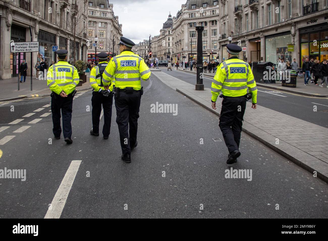 London, UK – Feb 4, 2023: Police walking in front of Iranian Protesters as they march toward Trafalgar Sq. About two hundred British-Iranians from different political backgrounds marched from Cavendish Square to Trafalgar Square, asking the UK government to put the Islamic Revolutionary Guard Corps of Iran on its terrorist list.  Credit: Sinai Noor/Alamy Live News Stock Photo