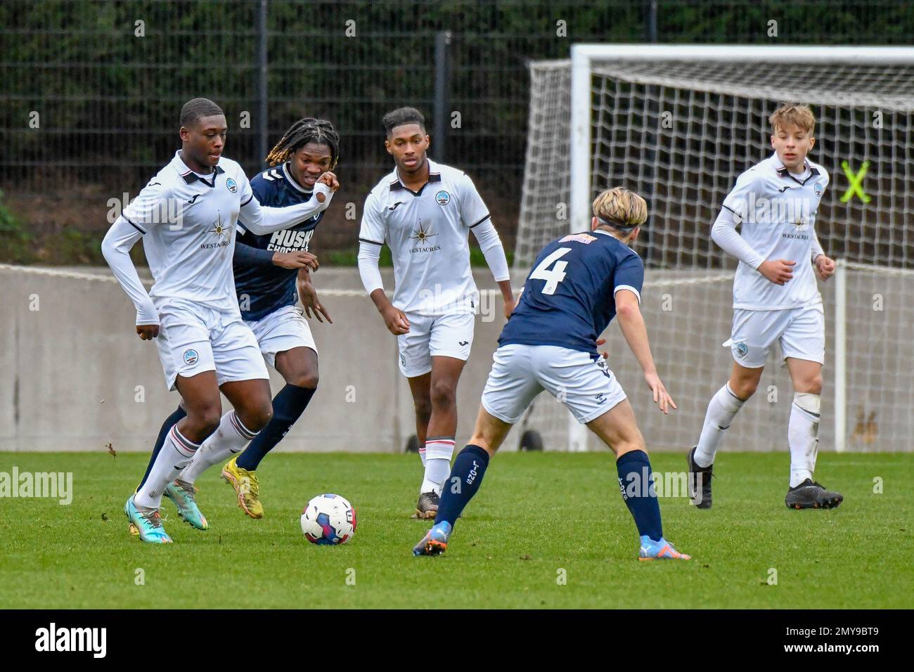 Swansea, Wales. 4 February 2023. Oliver Evans of Millwall under pressure  from Zane Myers of Swansea City during the Professional Development League  game between Swansea City Under 18 and Millwall Under 18