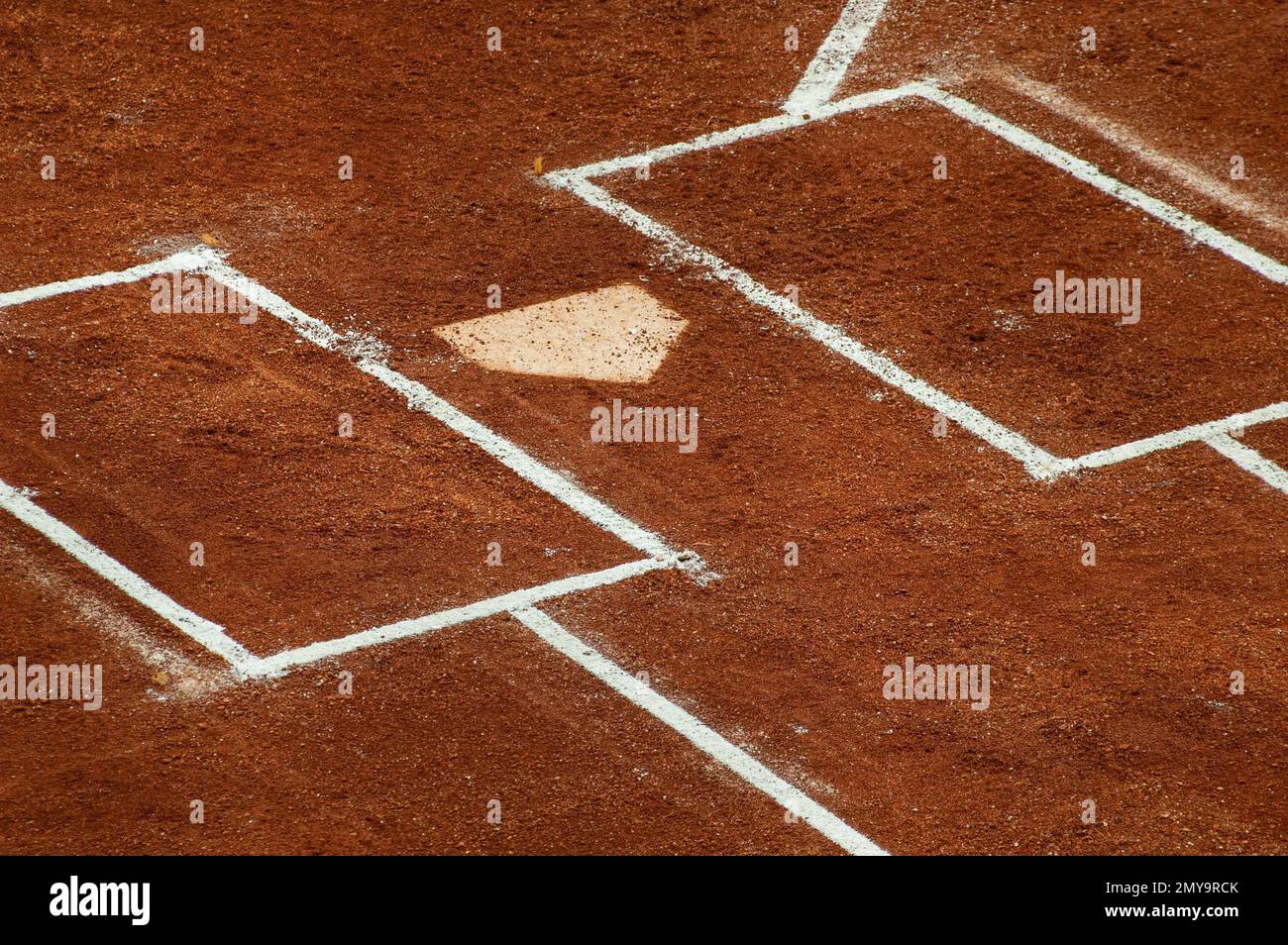 The home of the first base with white chalk lines in a baseball field
