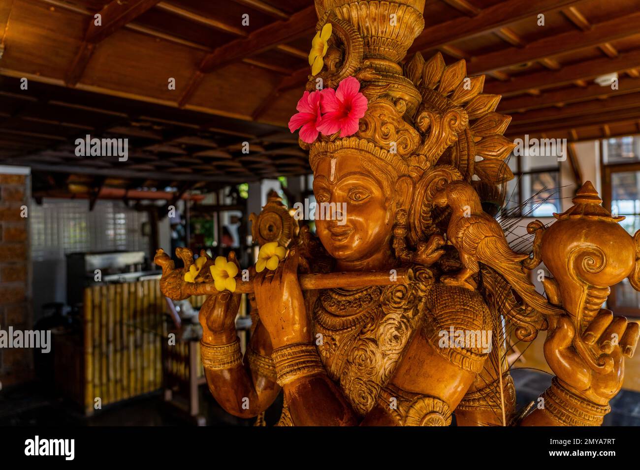 Wood carving sculpture of Lord Krishna close up. Selective focus. High