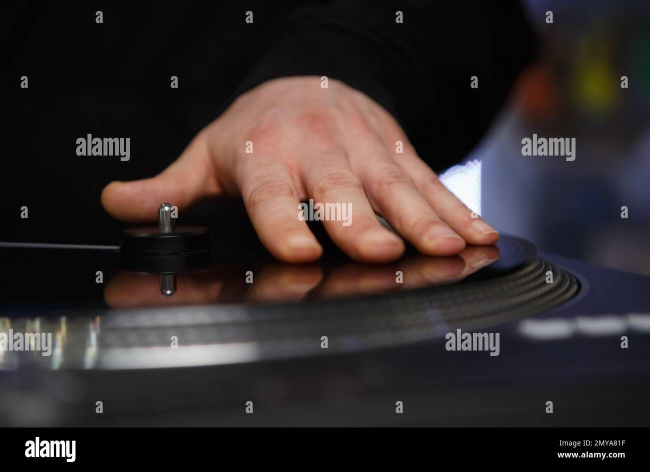 Hand of hip hop dj scrathing vinyl record on turntable. Professional