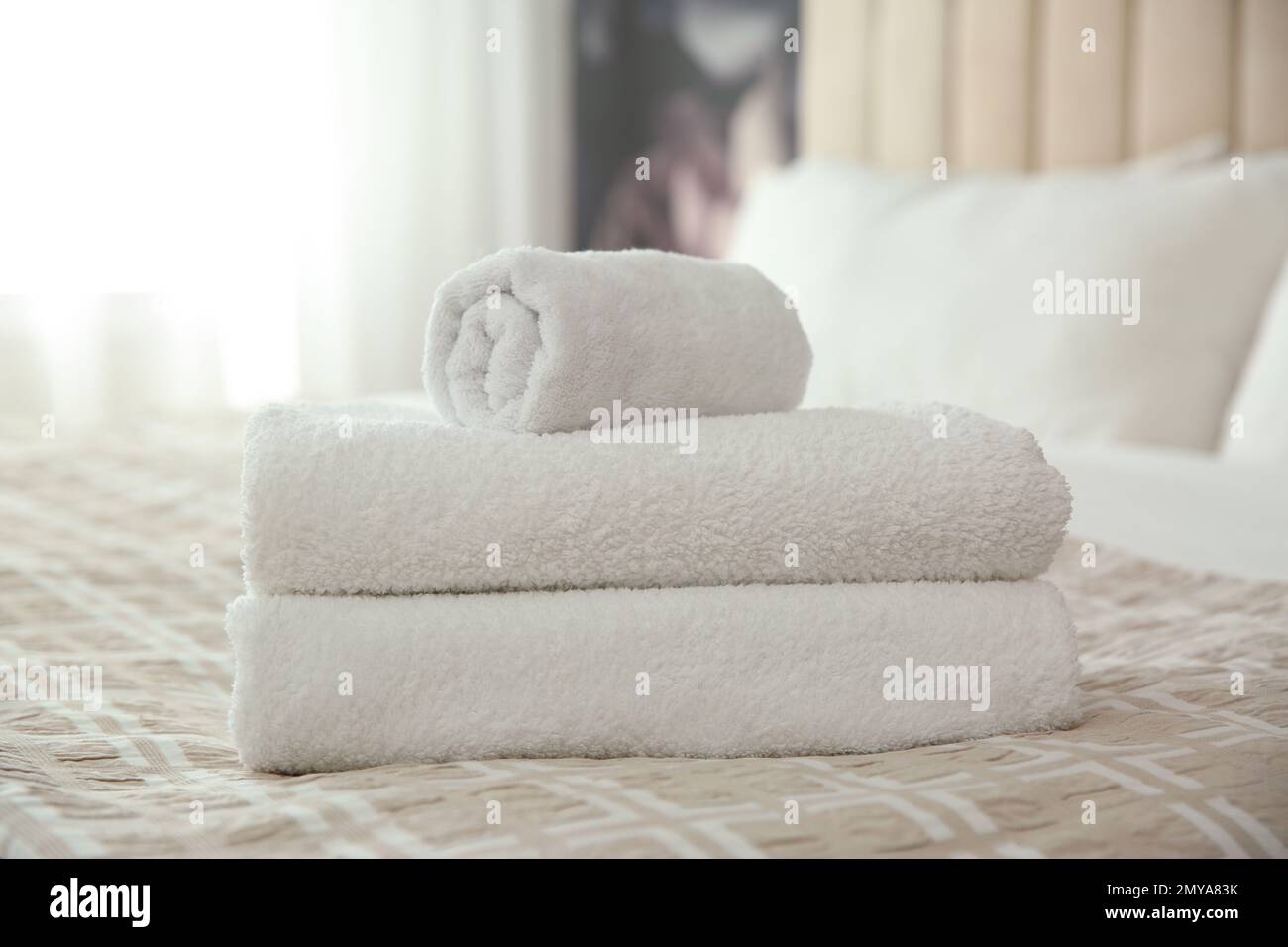 Clean white towels on bed at home Stock Photo Alamy