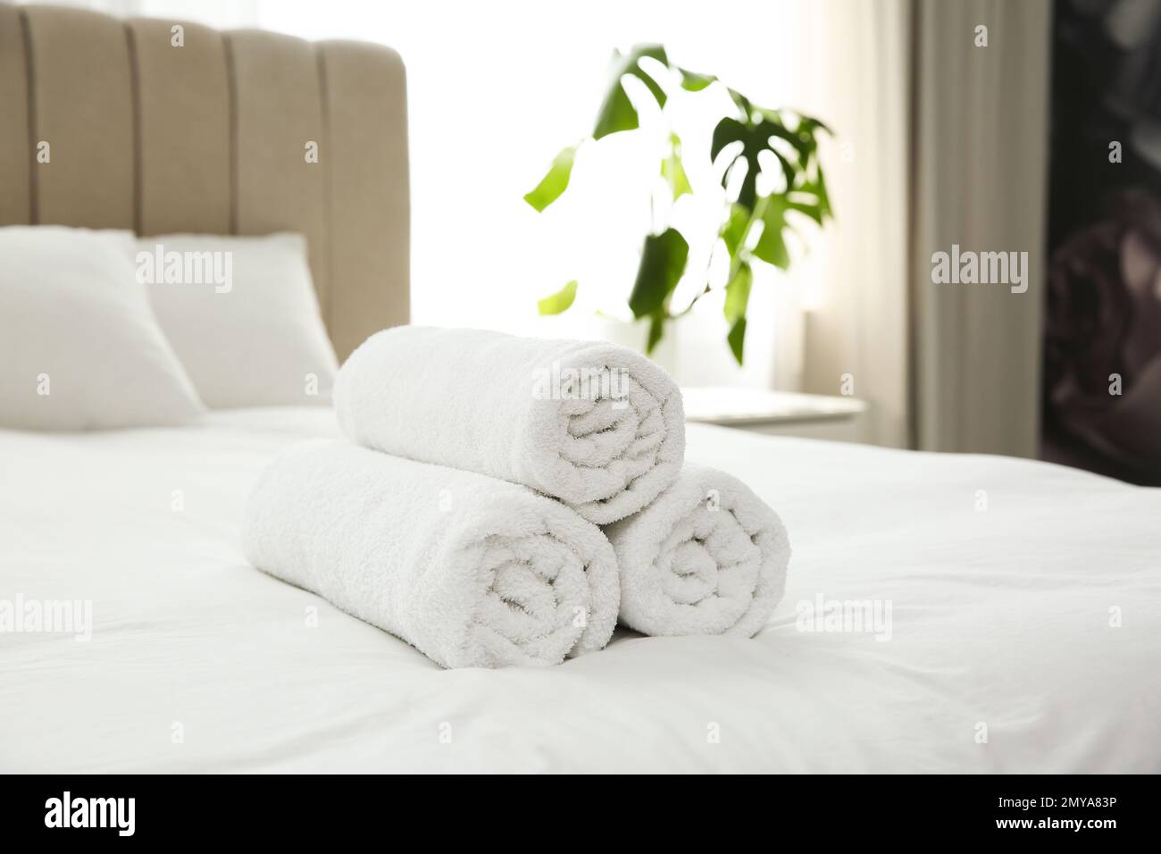 Clean white towels on bed at home Stock Photo Alamy