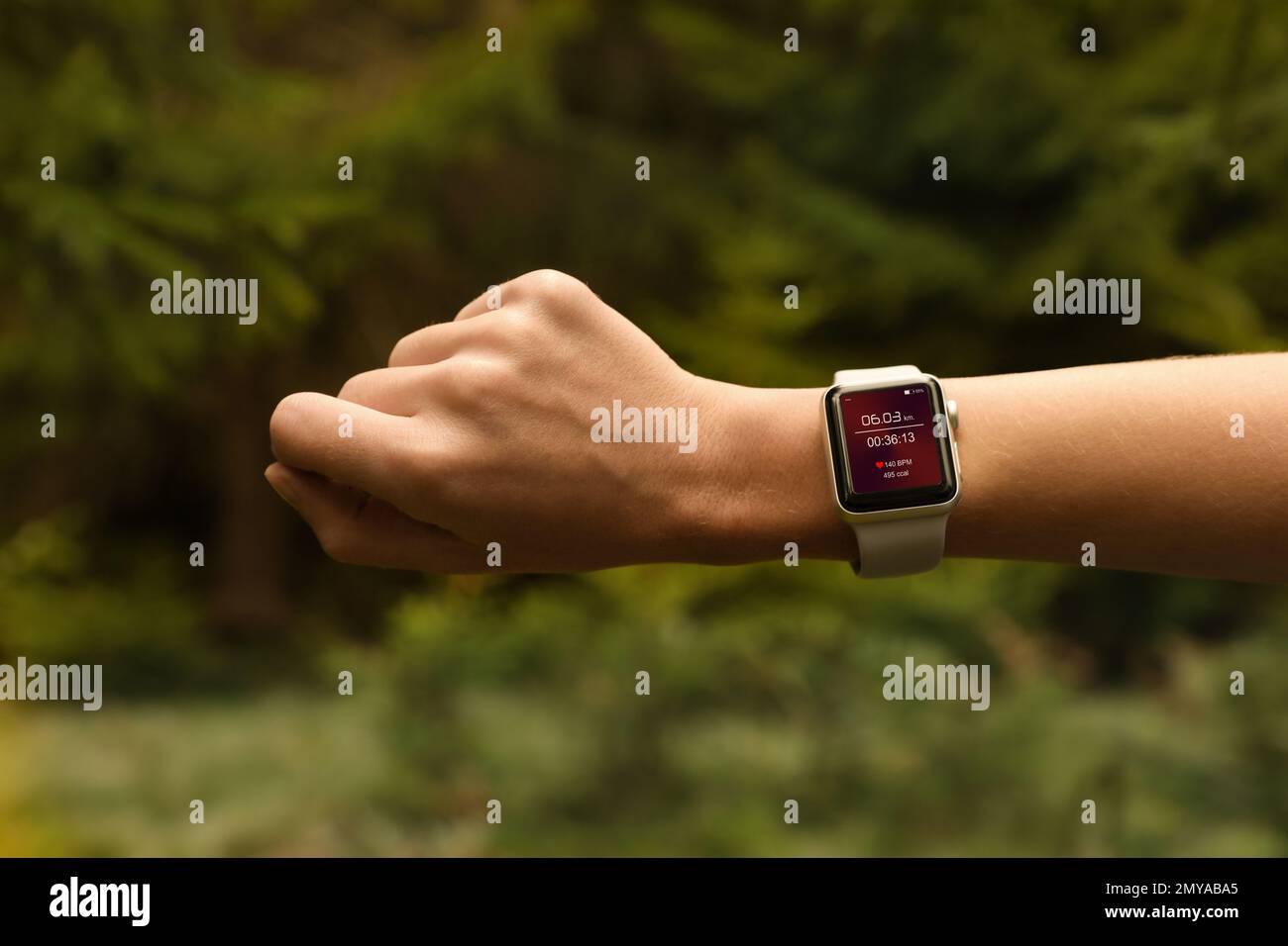 Woman with smart watch checking time interval, distance, heart rate and