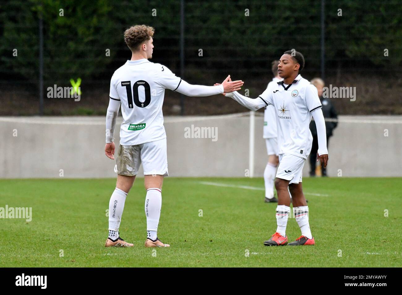 Swansea, Wales. 4 February 2023. Iwan Morgan of Swansea City high fives  Aimar Govea of Swansea City during the Professional Development League game  between Swansea City Under 18 and Millwall Under 18