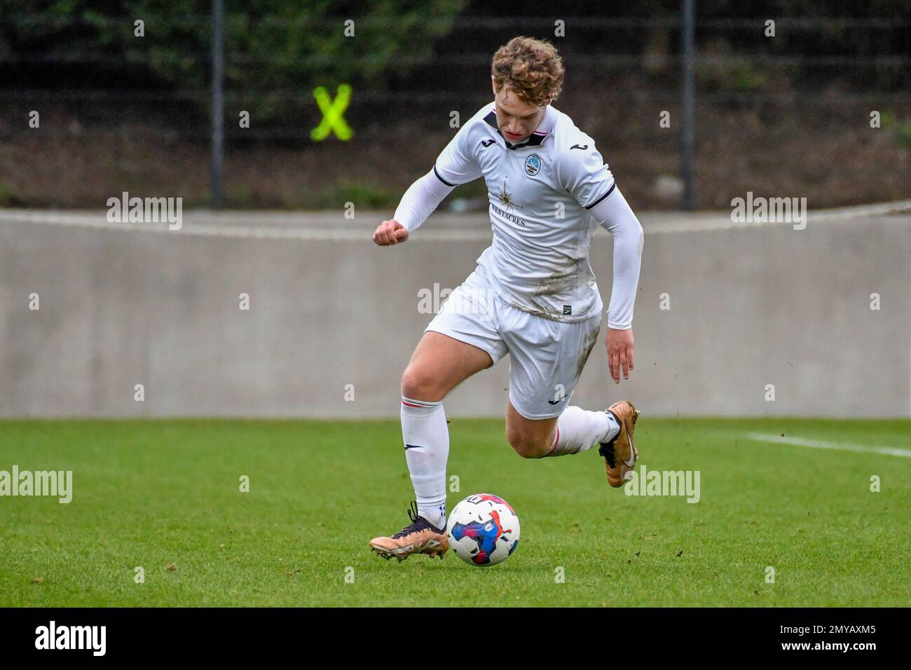 Swansea, Wales. 4 February 2023. Iwan Morgan of Swansea City high fives  Aimar Govea of Swansea City during the Professional Development League game  between Swansea City Under 18 and Millwall Under 18