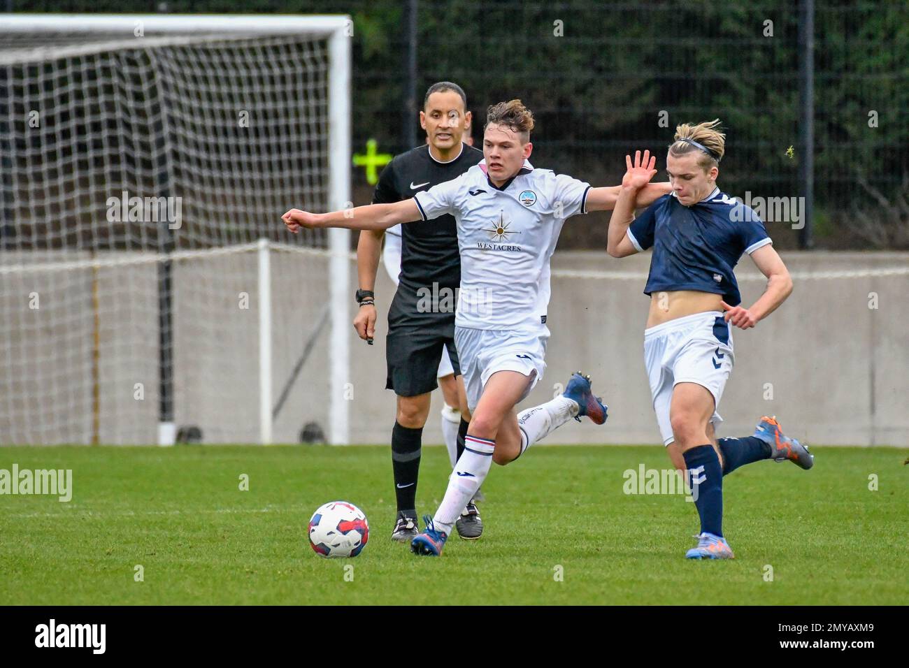 Swansea, Wales. 4 February 2023. Oliver Evans of Millwall under pressure  from Zane Myers of Swansea City during the Professional Development League  game between Swansea City Under 18 and Millwall Under 18