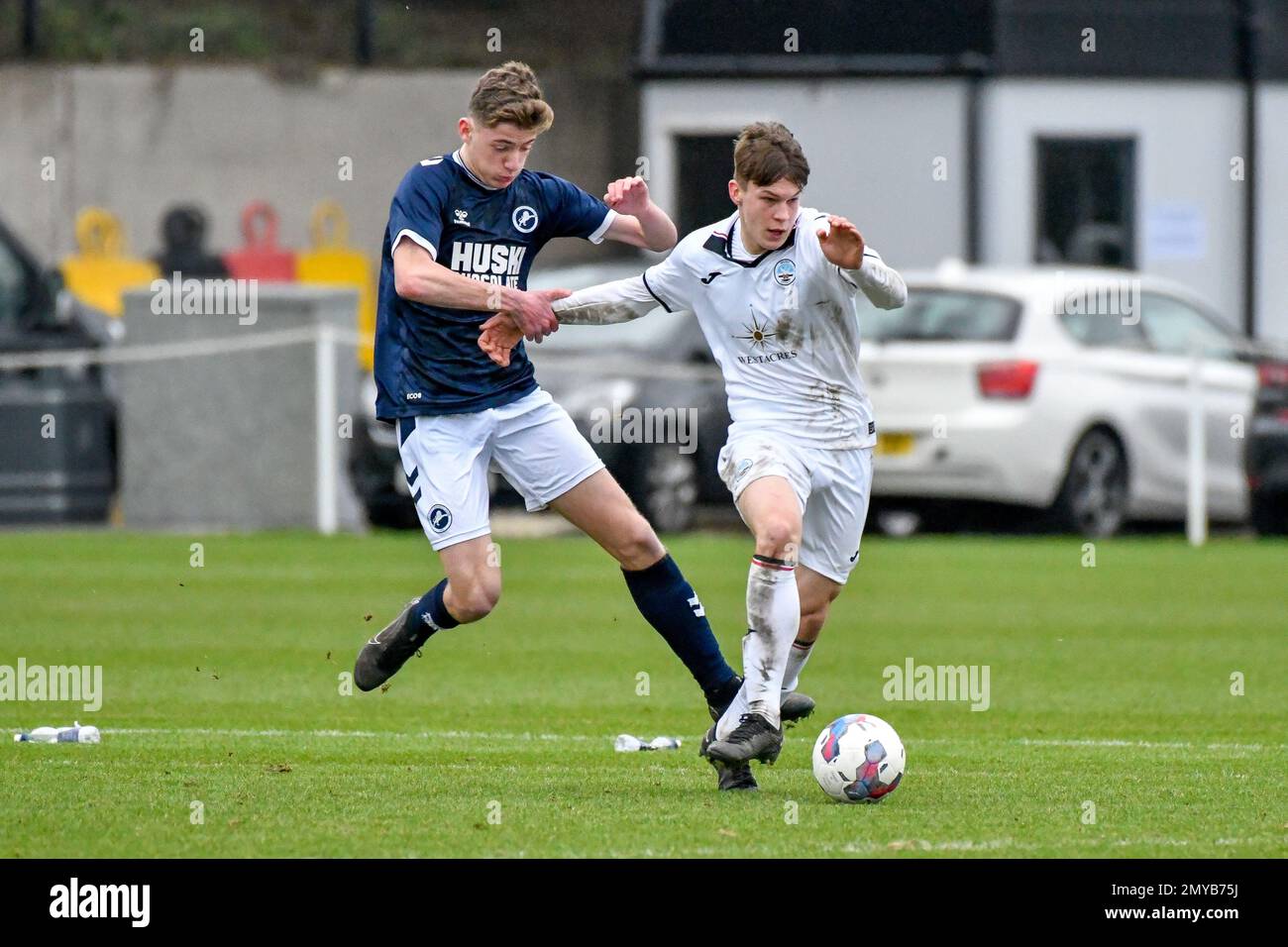Swansea, Wales. 4 February 2023. Richard Faakye of Swansea City holds off  the challenge from Jack Howland of Millwall during the Professional  Development League game between Swansea City Under 18 and Millwall