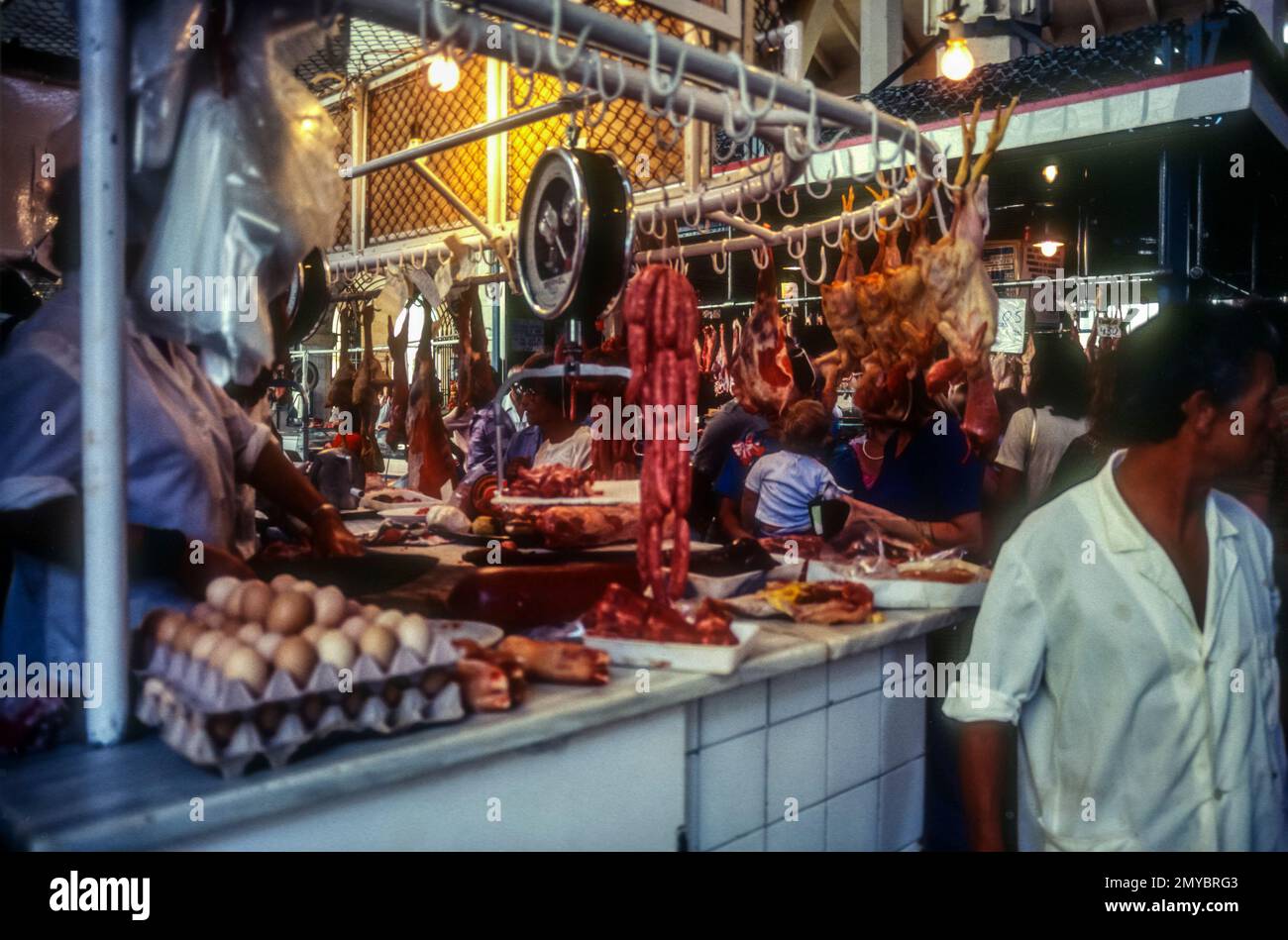 1981 archive image of butcher's stall in market hall at Felanitx, Majorca, Spain. Stock Photo
