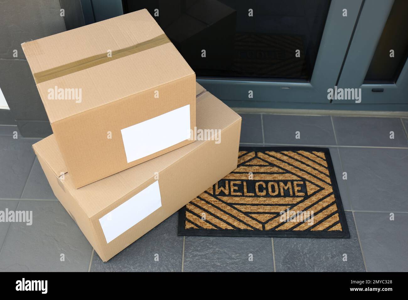 Cardboard boxes near door. Parcel delivery service Stock Photo Alamy