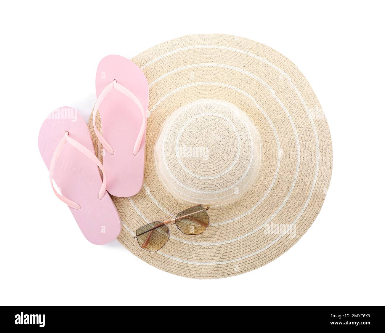 Pink flip flops, hat and sunglasses on white background, top view. Beach objects Stock Photo