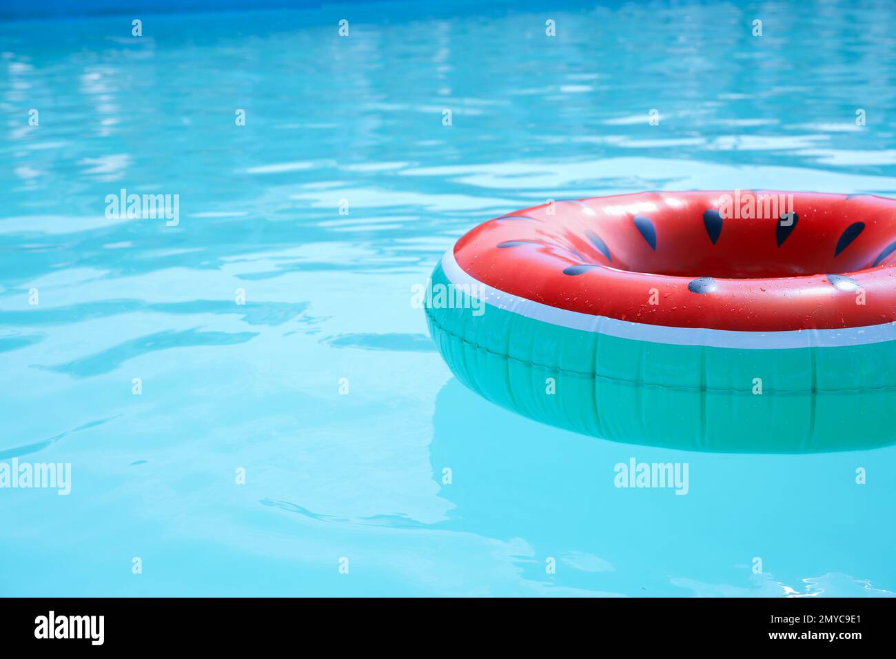 Inflatable ring in swimming pool on sunny day. Space for text Stock