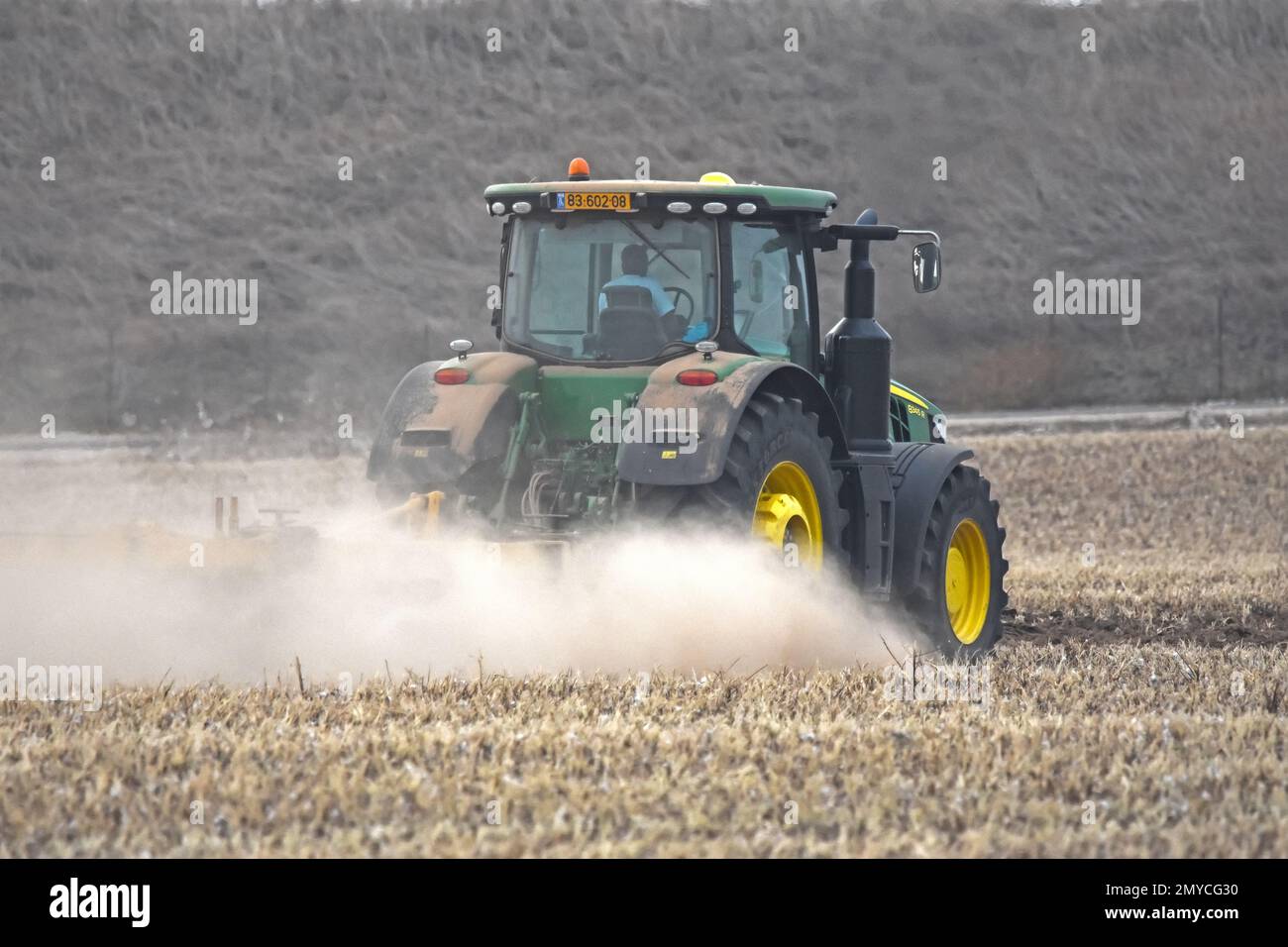 Tractor  plowing soil in the field Stock Photo