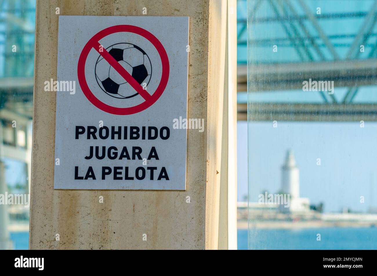 Sign that prohibits playing ball in Malaga, Spain. Text translation ...