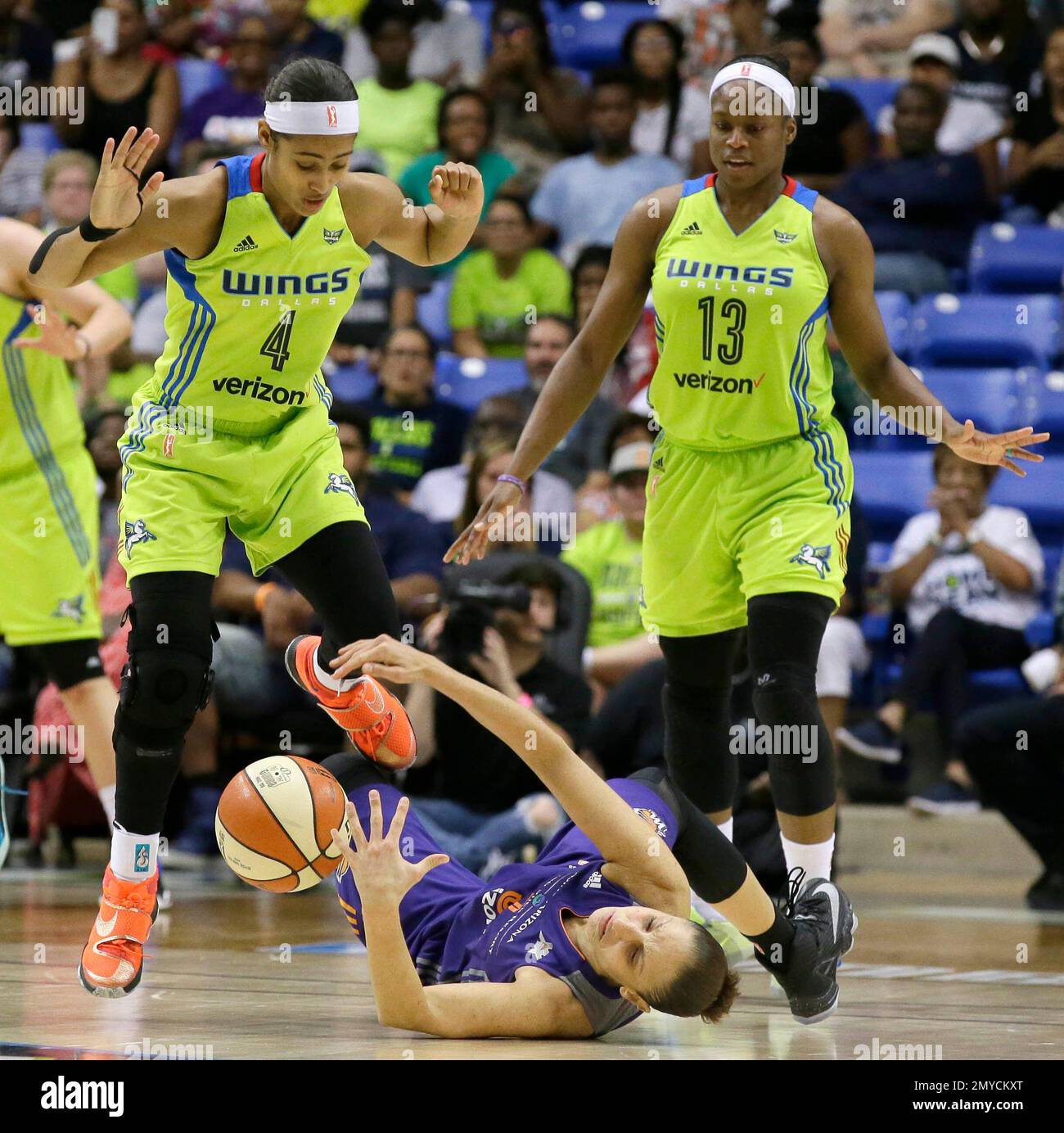 Phoenix Mercury guard Diana Taurasi, bottom, falls in front of Dallas