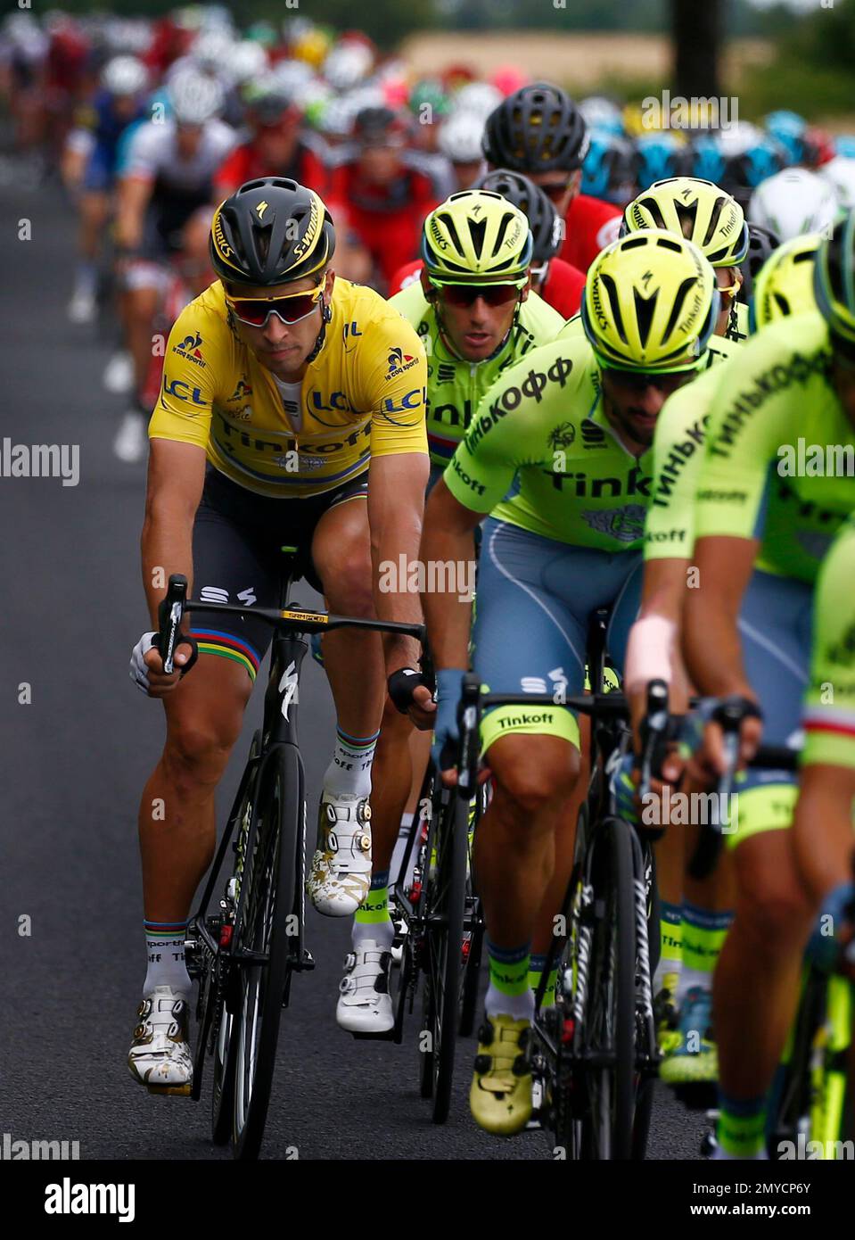 Peter Sagan of Slovakia, wearing the overall leader's yellow jersey, left,  rides in the pack during the fourth stage of the Tour de France cycling  race over 237.5 kilometers (147.3 miles) with