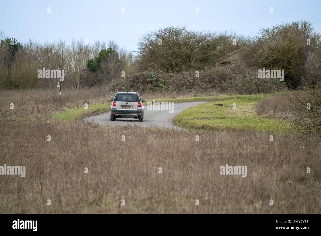 silver skoda yeti motor car driving on a country lane across Salisbury