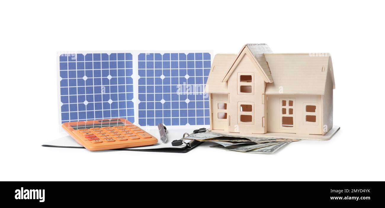 Composition with solar panels and wooden house model on white background Stock Photo