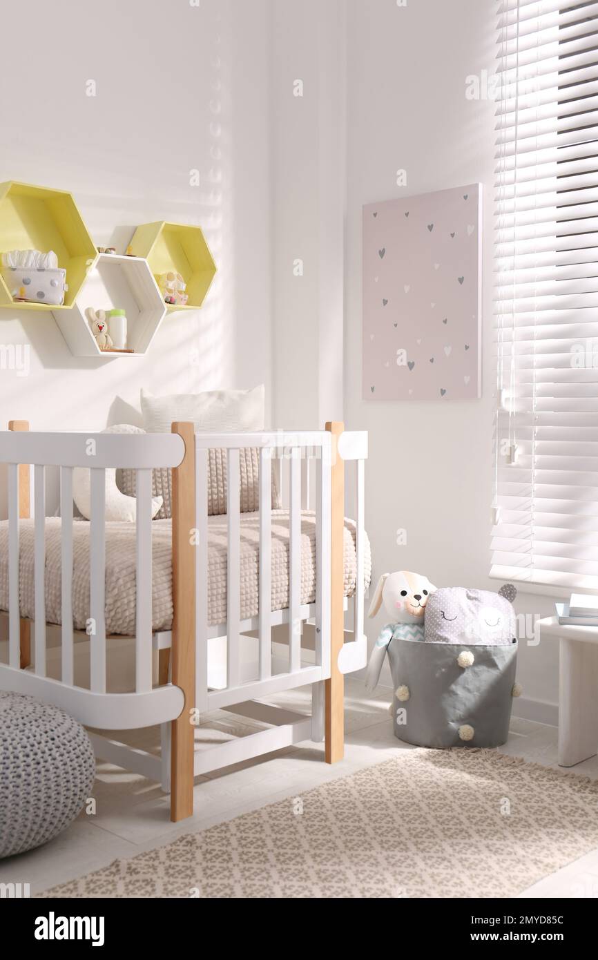 Hexagon shaped shelves on white wall in nursery. Interior design Stock ...