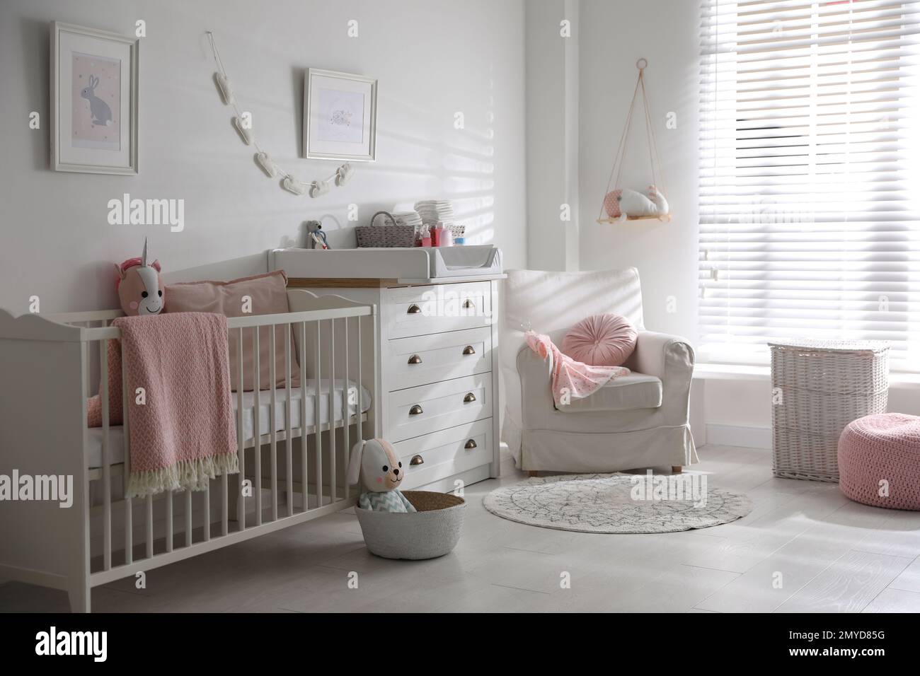 Chest of drawers with changing tray and pad in baby room. Interior