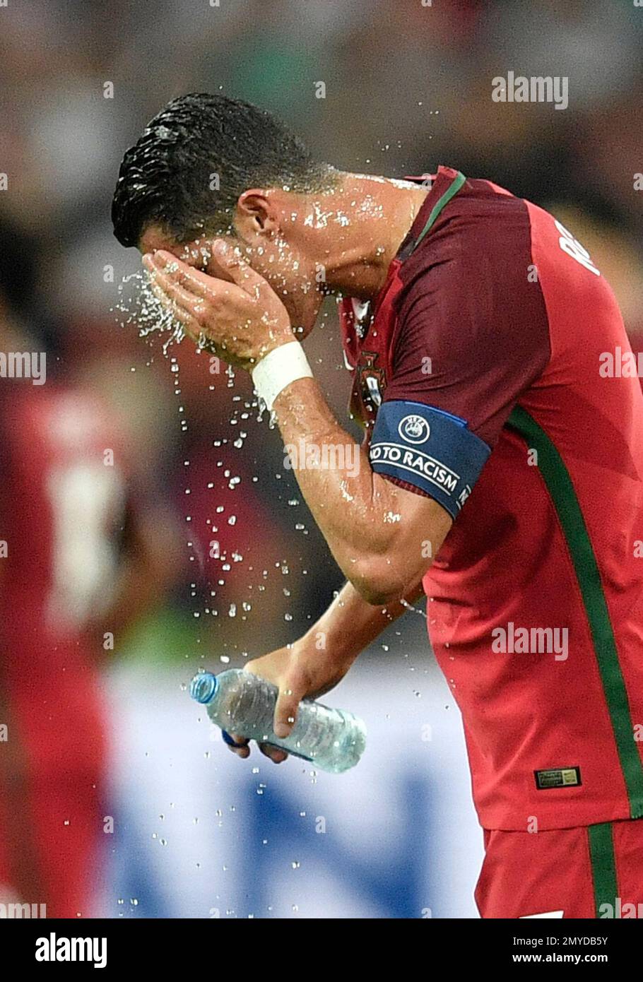 Portugal's Cristiano Ronaldo pours water into his face during the Euro 2016  quarterfinal soccer match between