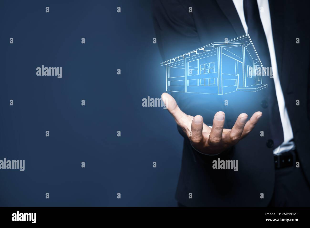 Real estate agent demonstrating house illustration on dark background,  closeup. Space for text Stock Photo - Alamy