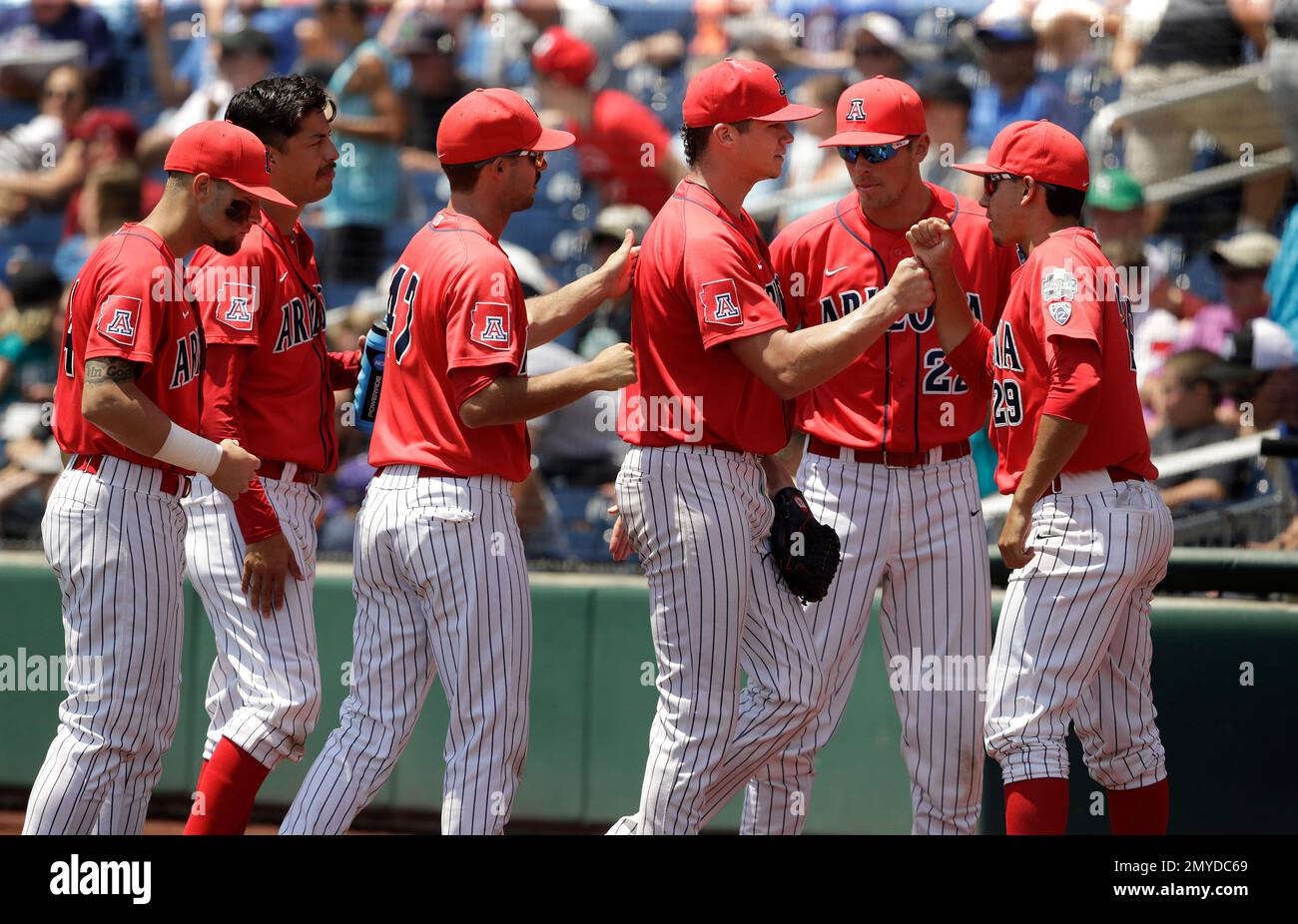 Arizona pitcher Bobby Dalbec, third from right, is congratulated