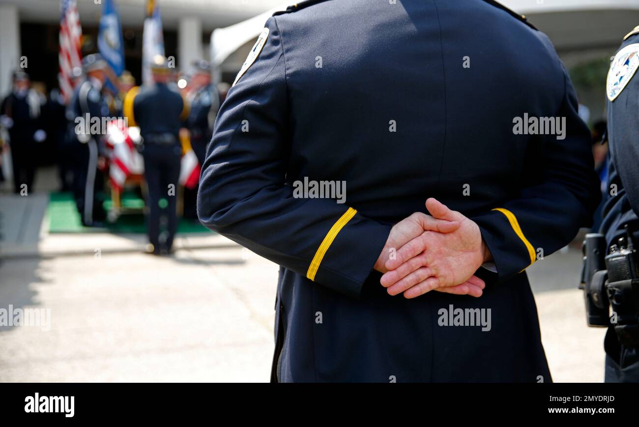 Officers stand at attention for the burial of Jefferson Parish Sheriff