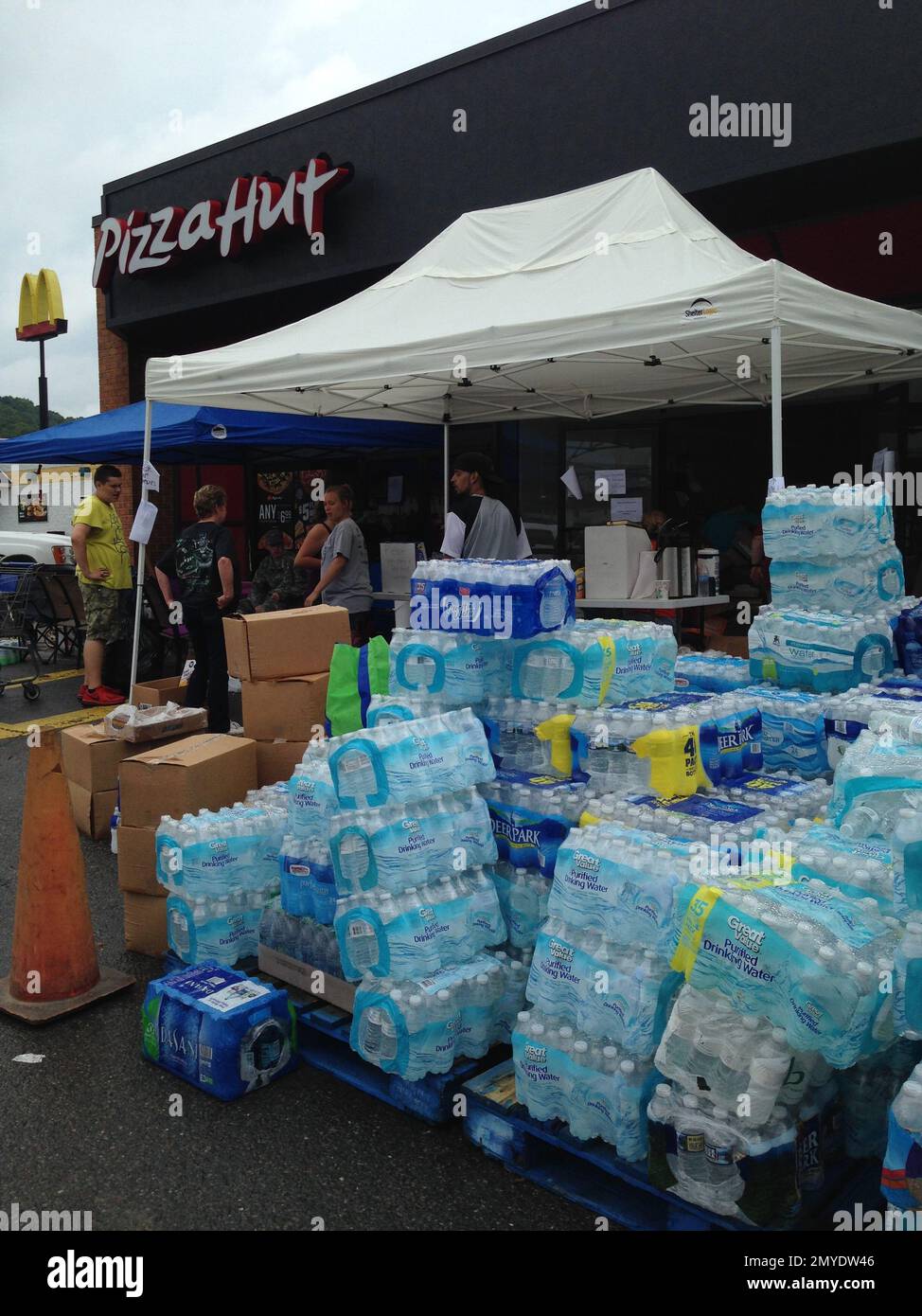 Donations of bottled water for flood victims pile up at a distribution