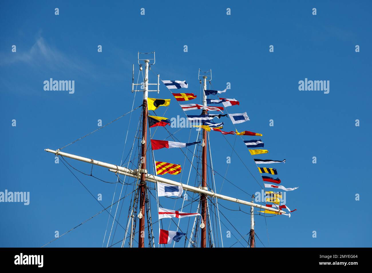 International maritime signal flags on a flagpole and masts on a