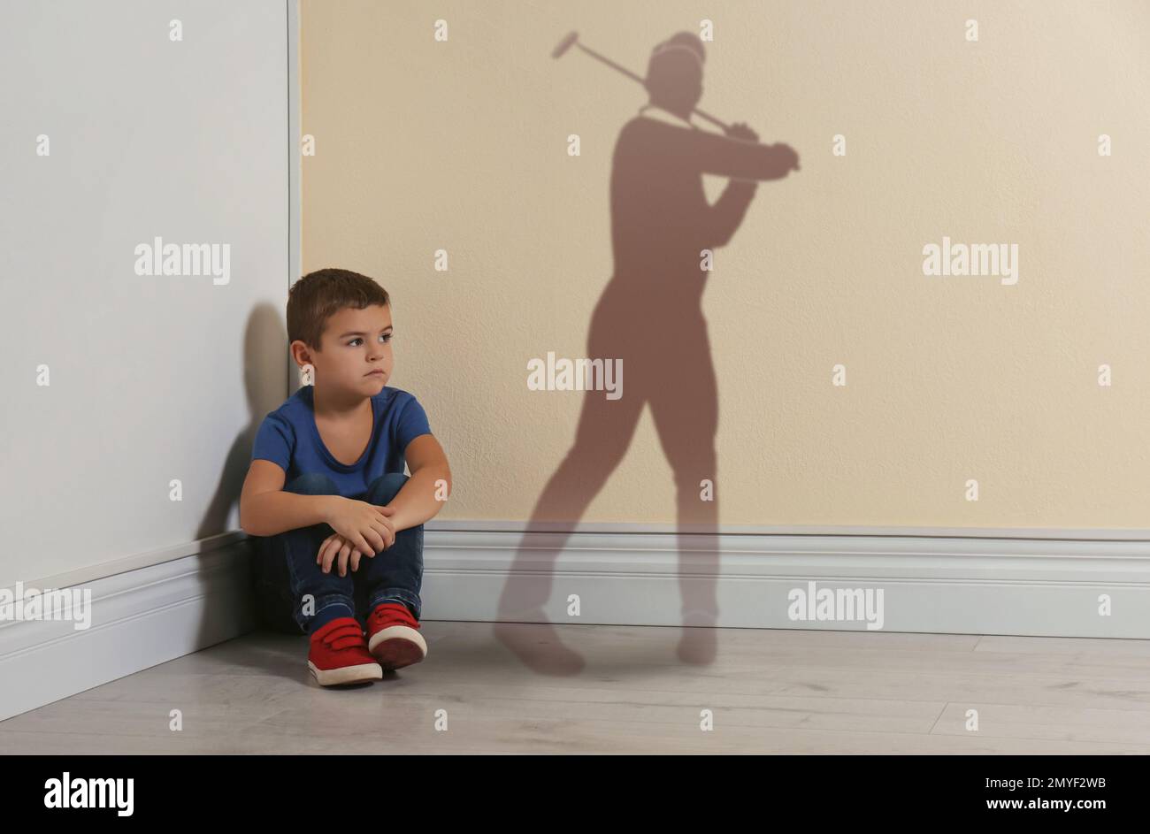 Little boy dreaming to be golf player. Silhouette of man behind kid's back Stock Photo
