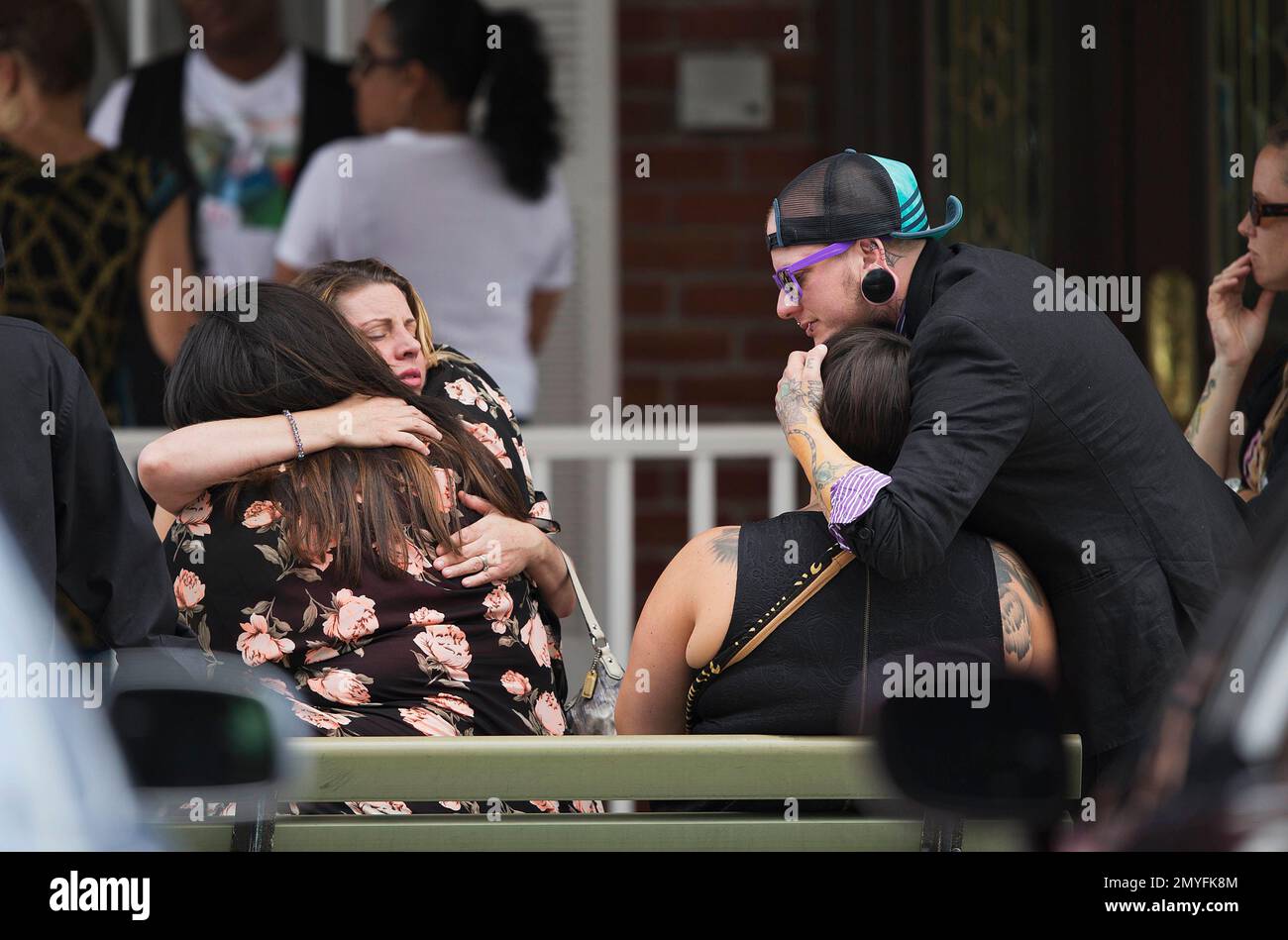 Mourners embrace before the funeral service for Kimberly Morris, one of the victims of the Pulse