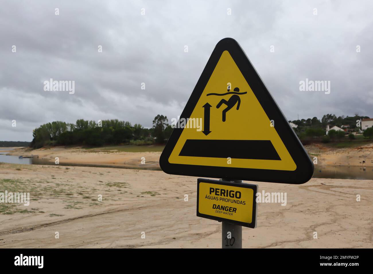 Deep water warning sign. Irony due to the climate change dam drought in Montargil Dam, Portugal Stock Photo