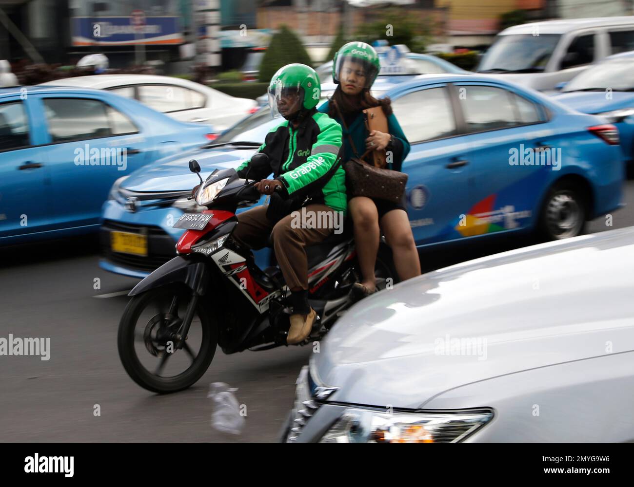 In this Friday, April 29, 2016, a driver of GrabBike, a direct