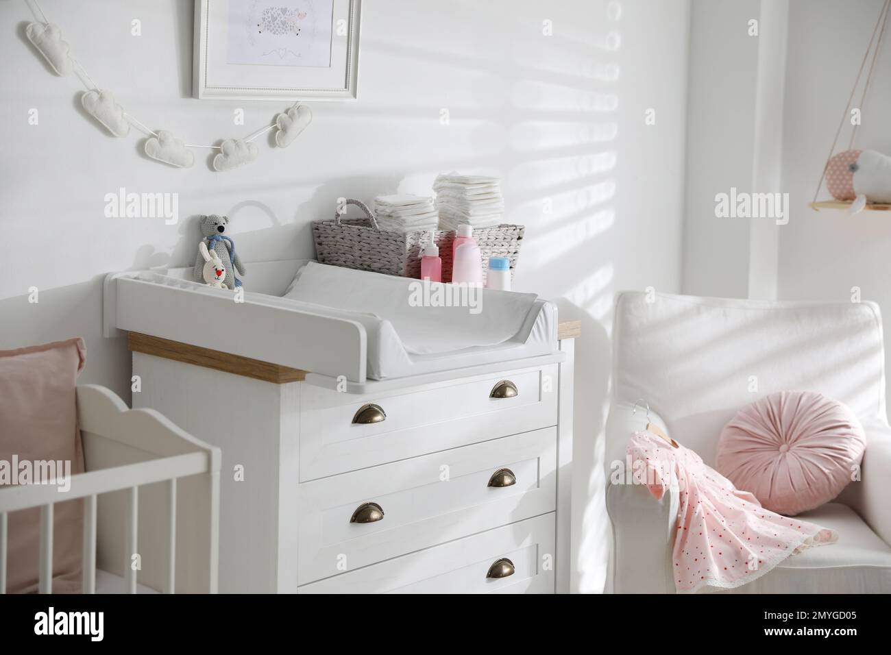 Chest of drawers with changing tray and pad in baby room. Interior ...