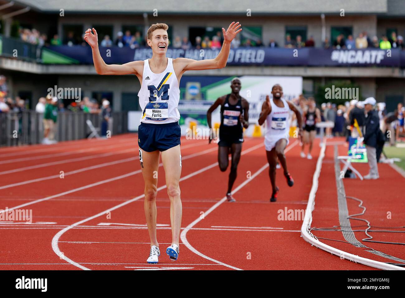 Michigan's Mason Ferlic reacts after finishing first in the men's 3000