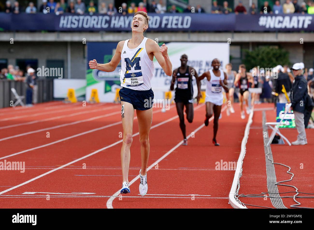 Michigan's Mason Ferlic reacts after finishing first in the men's 3000