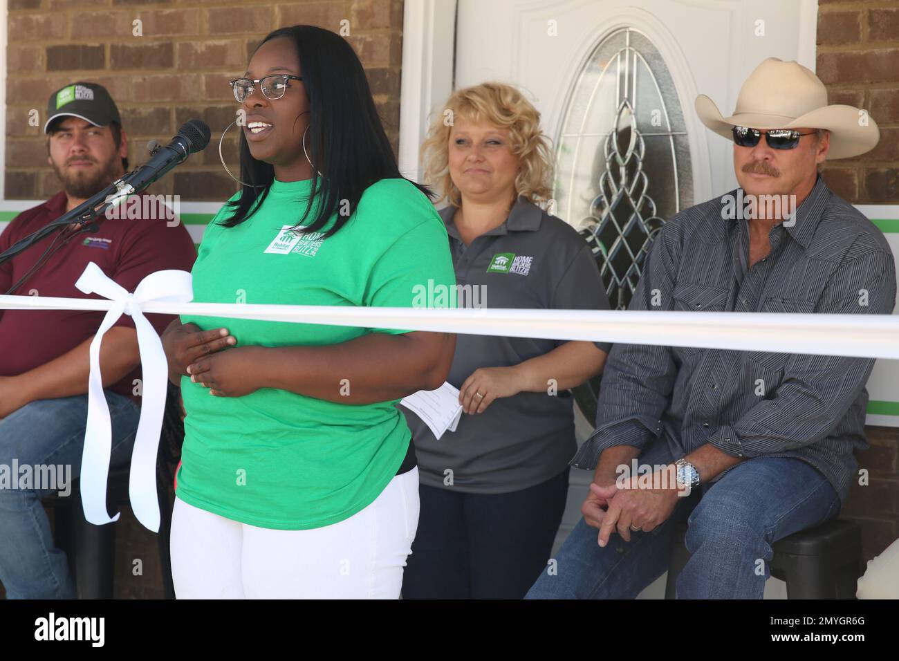 Far right, artist Alan Jackson listens on as front left, Habitat for