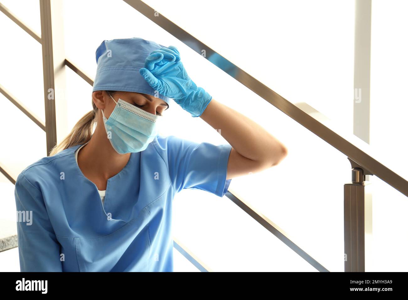 Exhausted doctor indoors. Stress of health care workers during COVID19