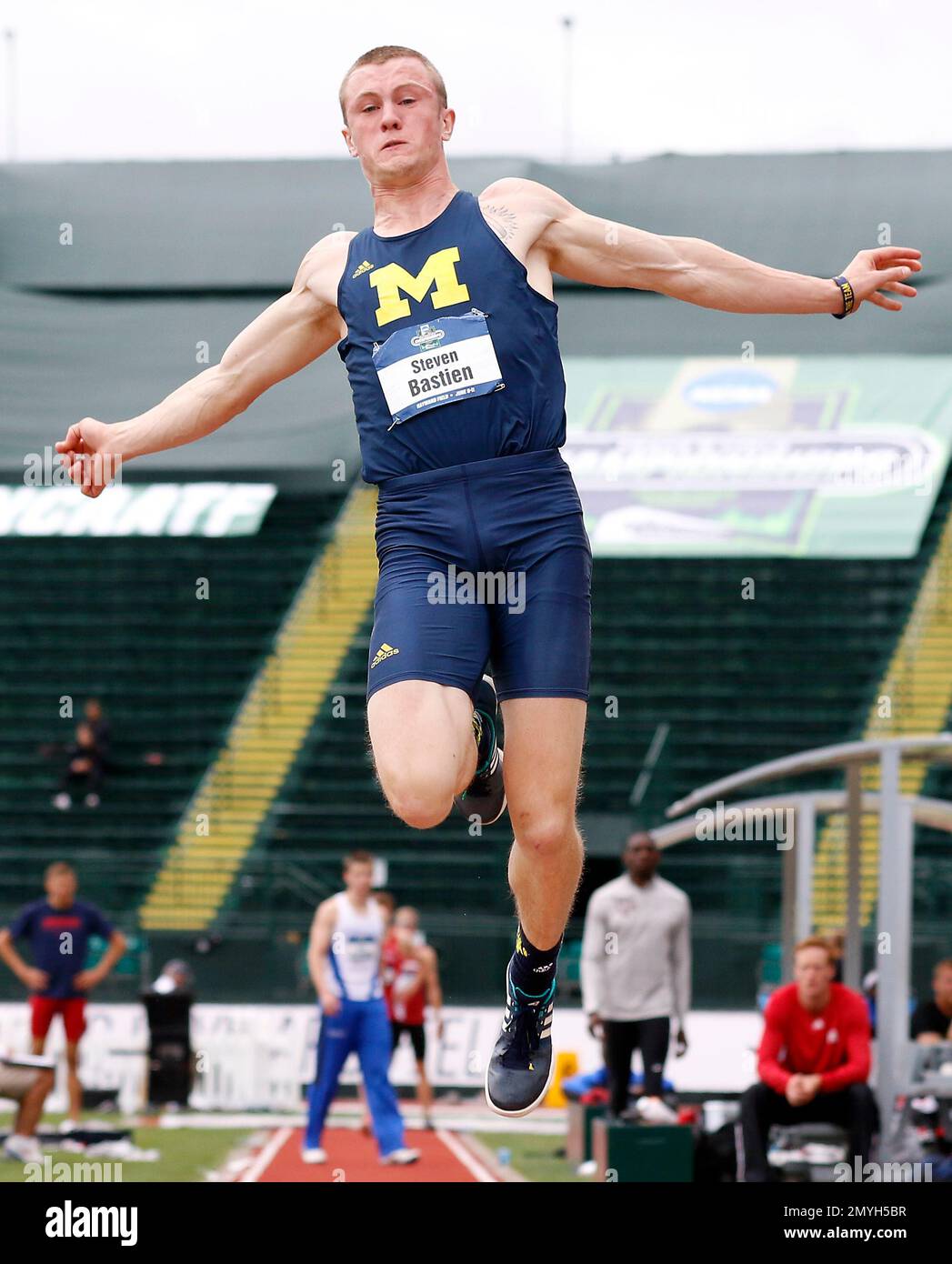 Michigan's Steven Bastien competes in the long jump event in the