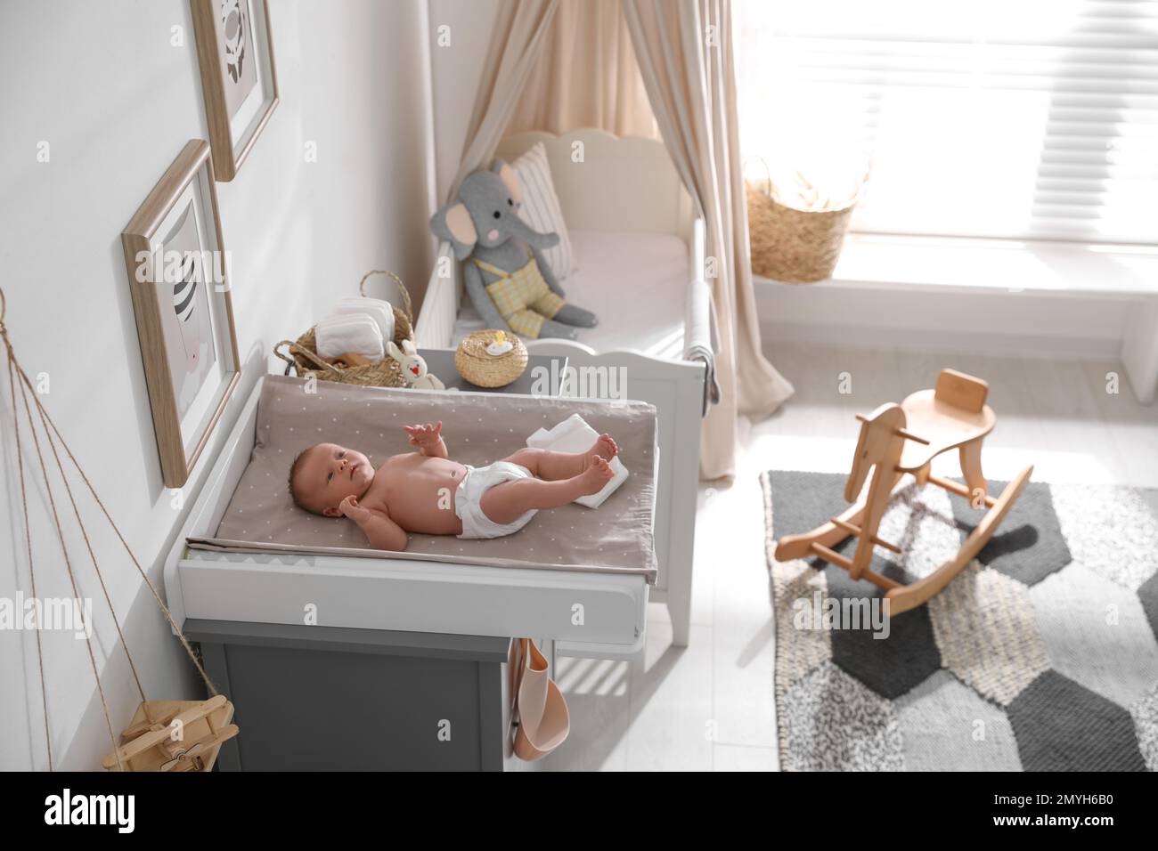 Cute little baby on changing table in room Stock Photo Alamy