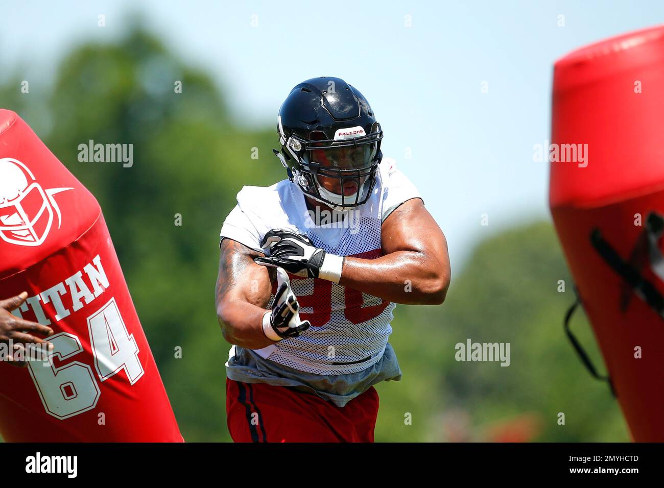 Atlanta Falcons defensive end Derrick Shelby (90) and head coach Dan Quinn  take the field prior to an NFL football game against the Denver Broncos,  Sunday, Oct. 9, 2016, in Denver. (AP